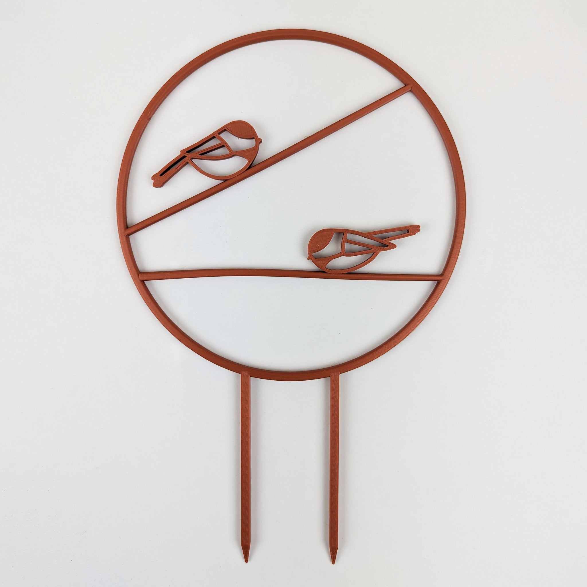 Chickadee trellis in copper, a circle with two chickadees on horizontal branches