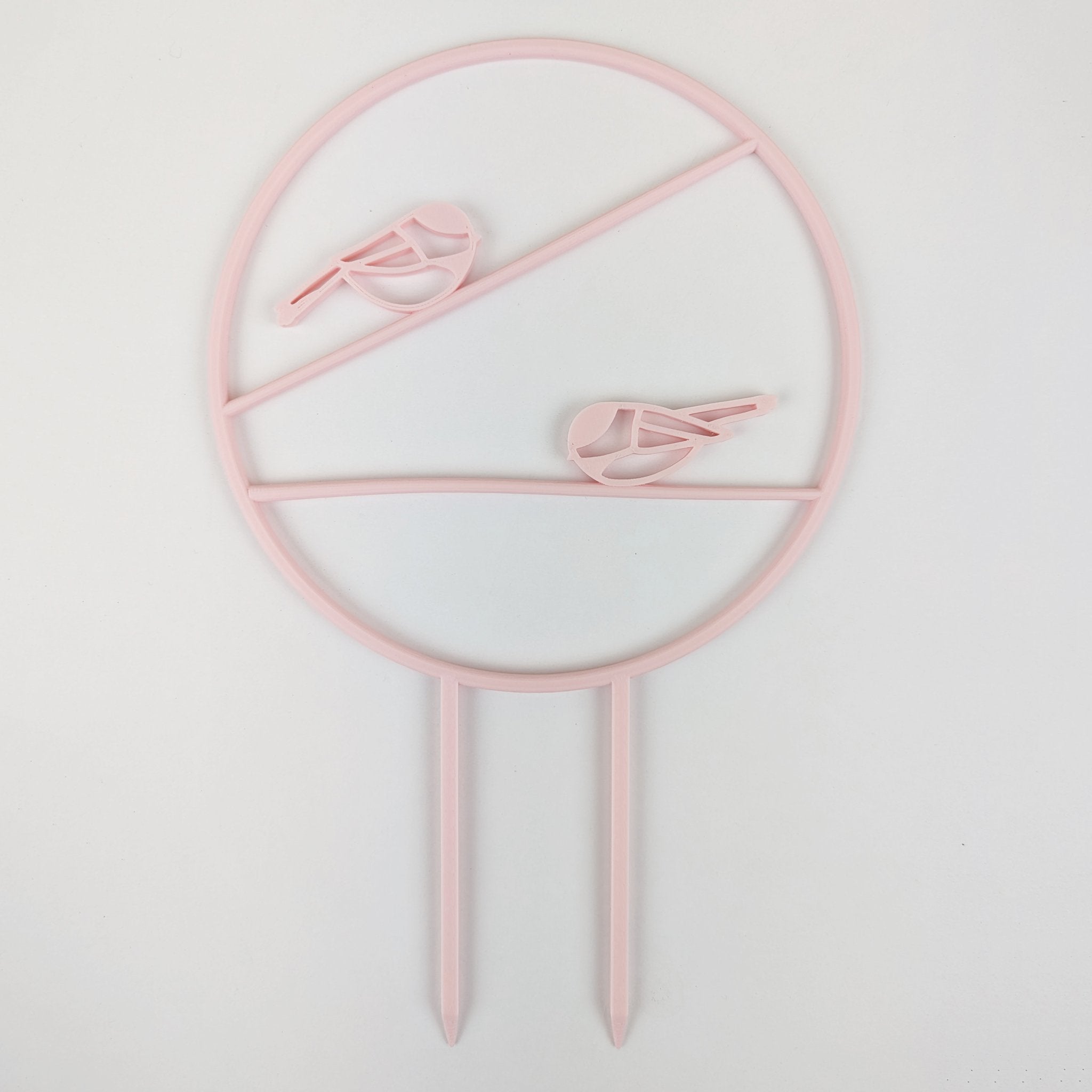Chickadee trellis in pastel pink, a circle with two chickadees on horizontal branches