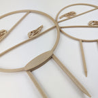 Two wood chickadee trellises angled to show the large size has a thicker base than the small