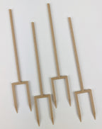 Set of four wooden plant supports on a white background