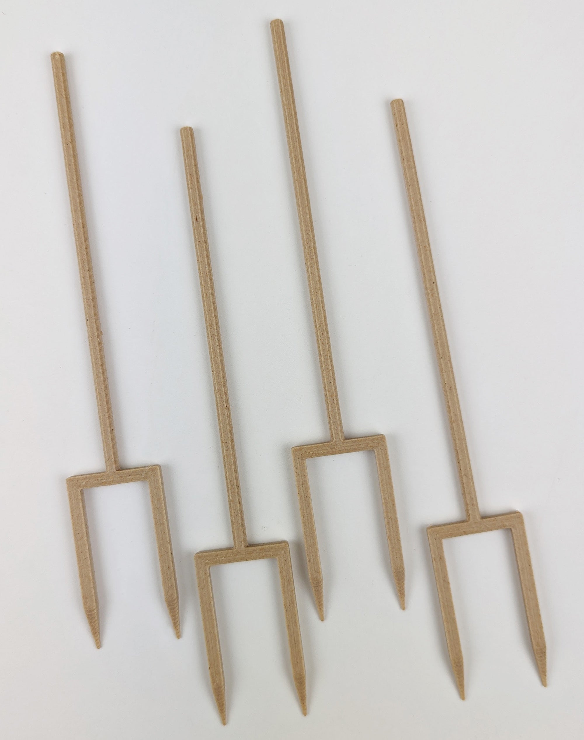 Set of four wooden plant supports on a white background