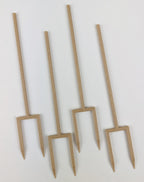 Set of four wood double legged plant stakes on a white background