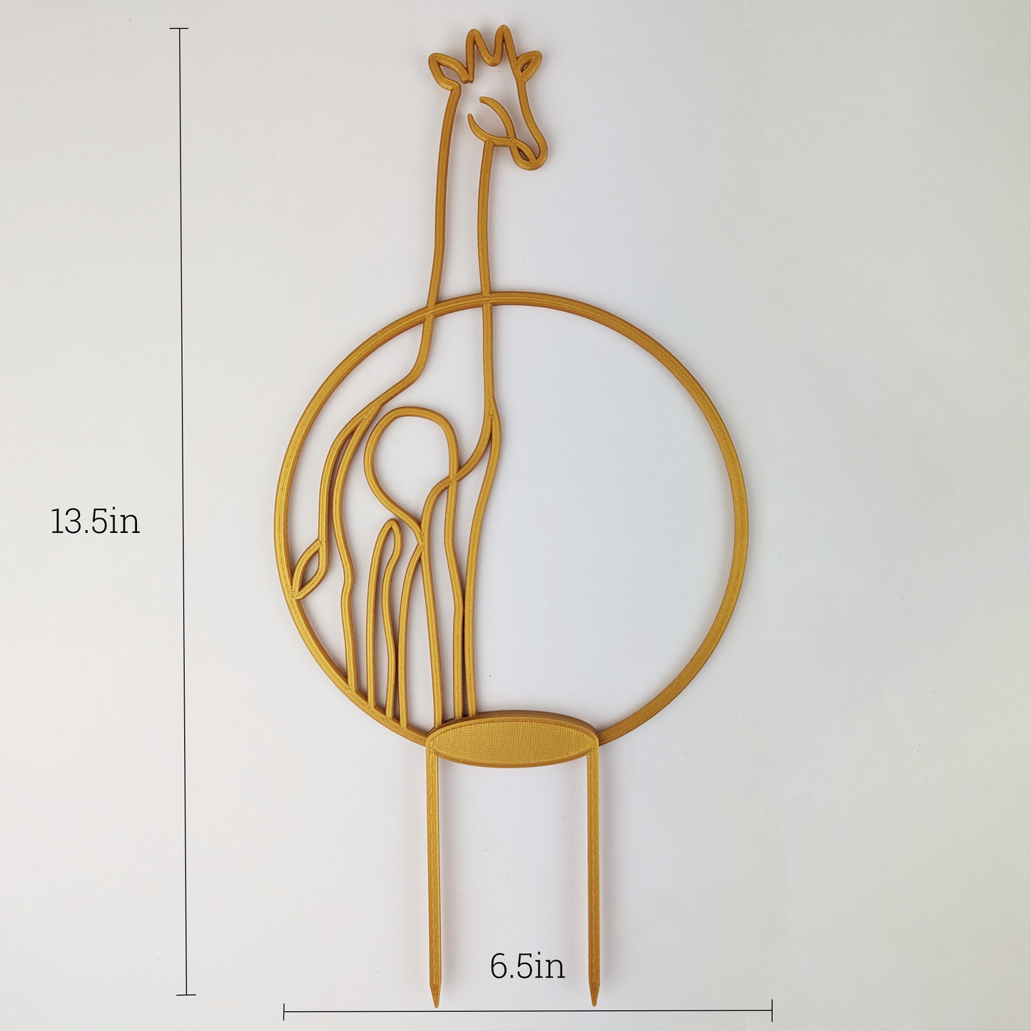 A gold circular trellis with a giraffe on it, the body is inside the circle but the head is poking out top. The dimensions are in the picture too. It is 13.5 inches tall and 6.5 inches wide.