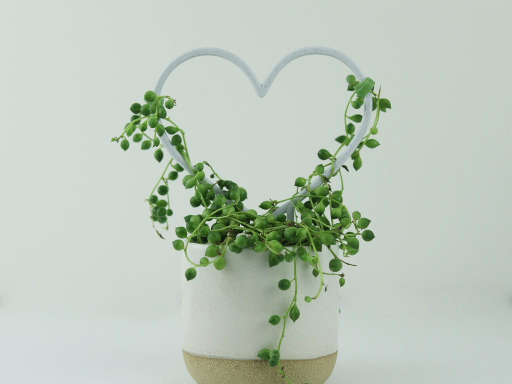 Marble small heart shaped trellis with string of pearls draped over it