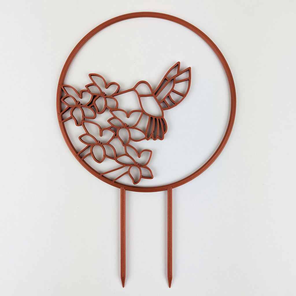 Hummingbird trellis in copper on a white background