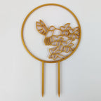 Hummingbird trellis in gold on a white background