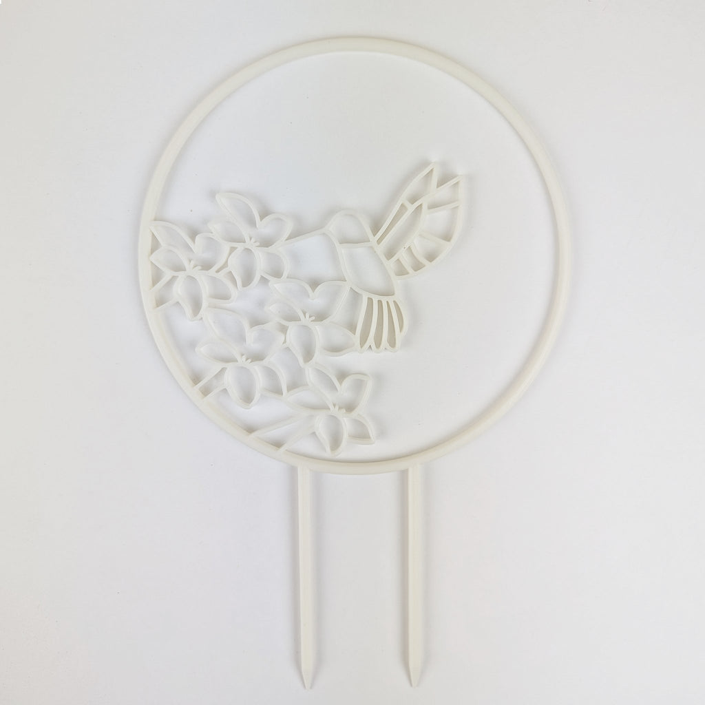 Hummingbird trellis in white on a white background