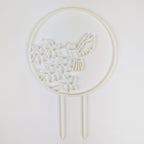 Hummingbird trellis in white on a white background