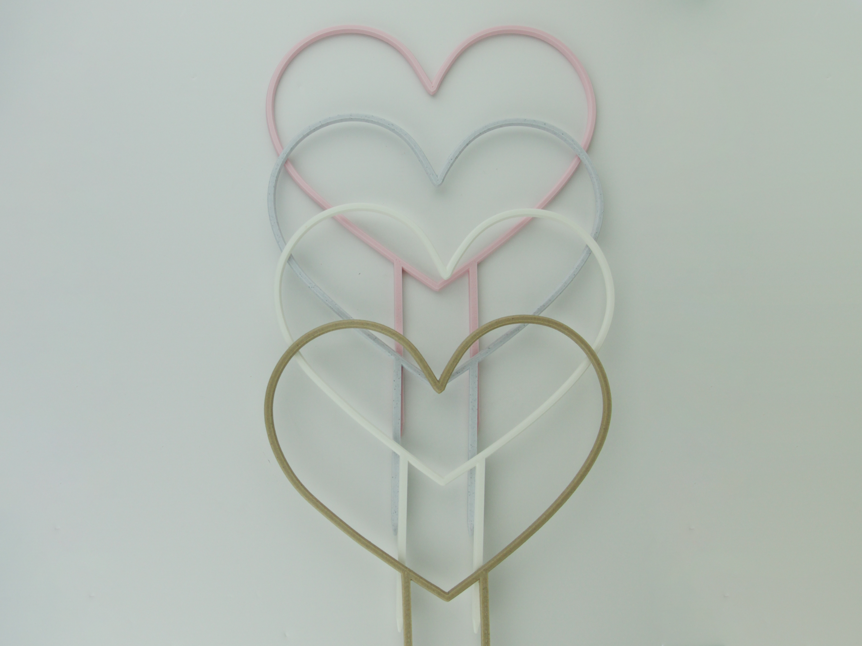 Pastel pink, Marble, White and Wood color heart shaped trellises.