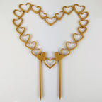 Open hearts trellis in gold on a white background