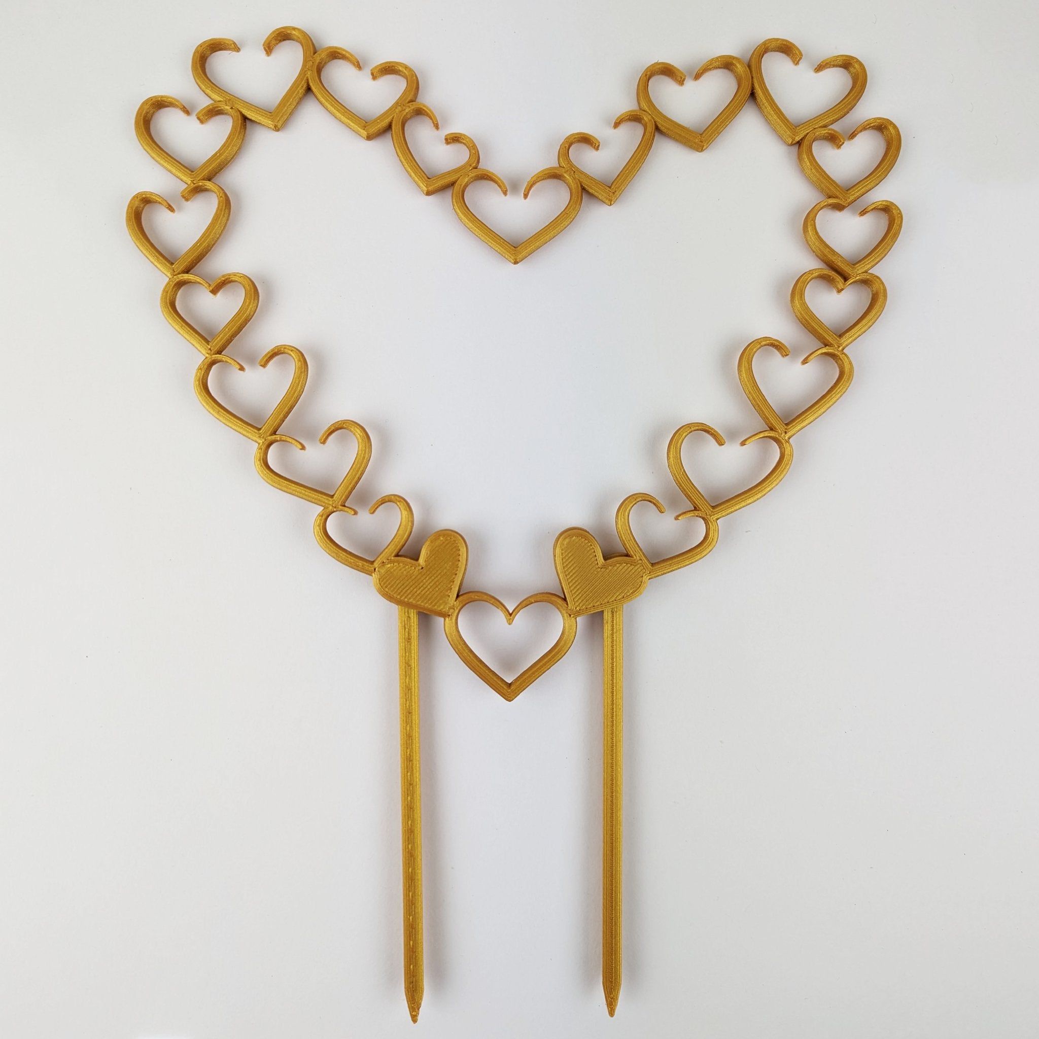 Open hearts trellis in gold on a white background