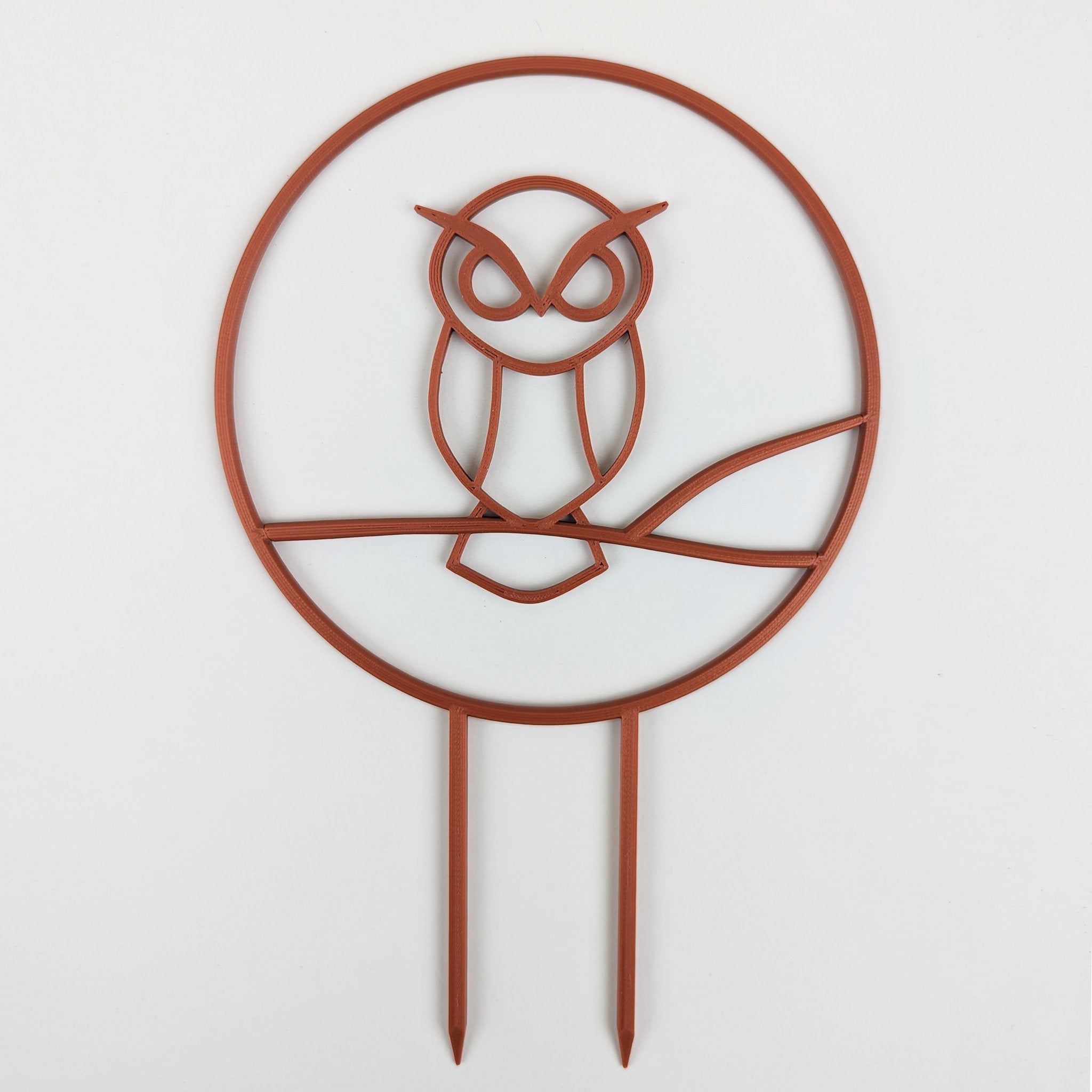 Owl trellis, a circle with an owl silhouette inside, in copper