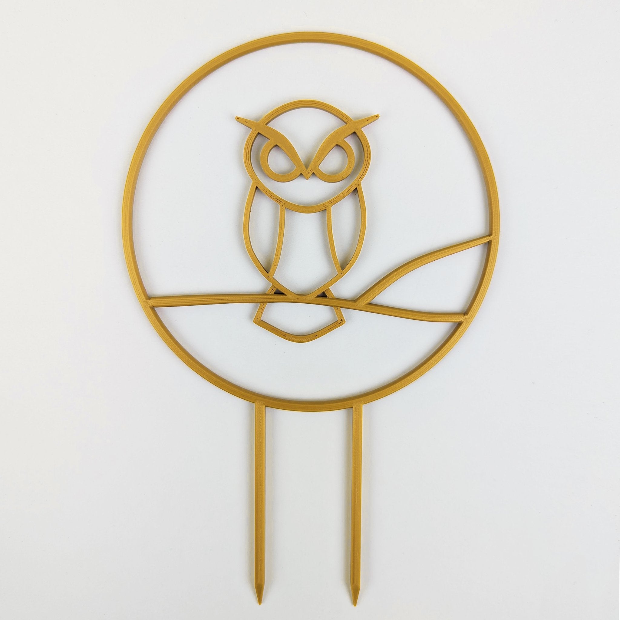 Owl trellis, a circle with an owl silhouette inside, in gold