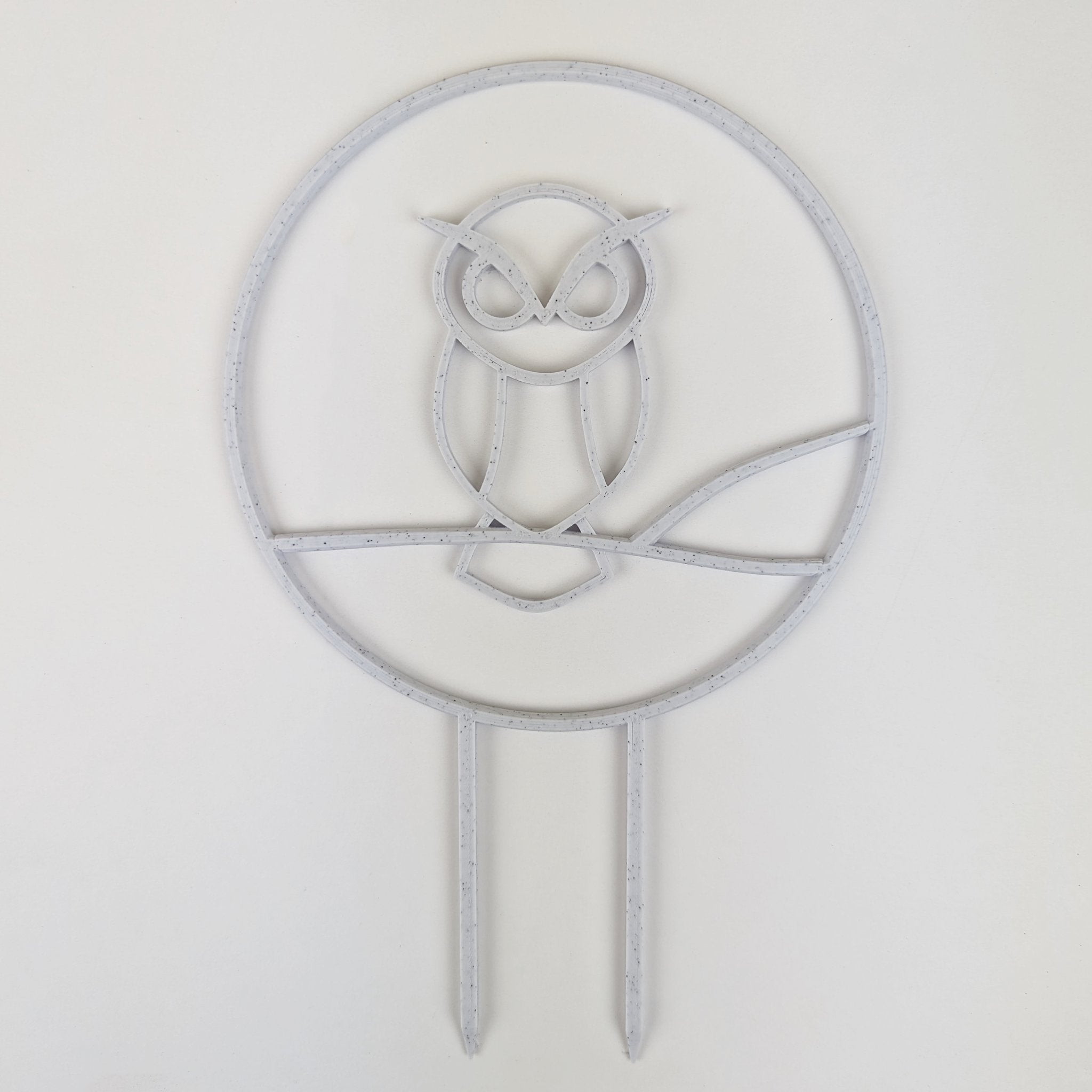 Owl trellis, a circle with an owl silhouette inside, in marble