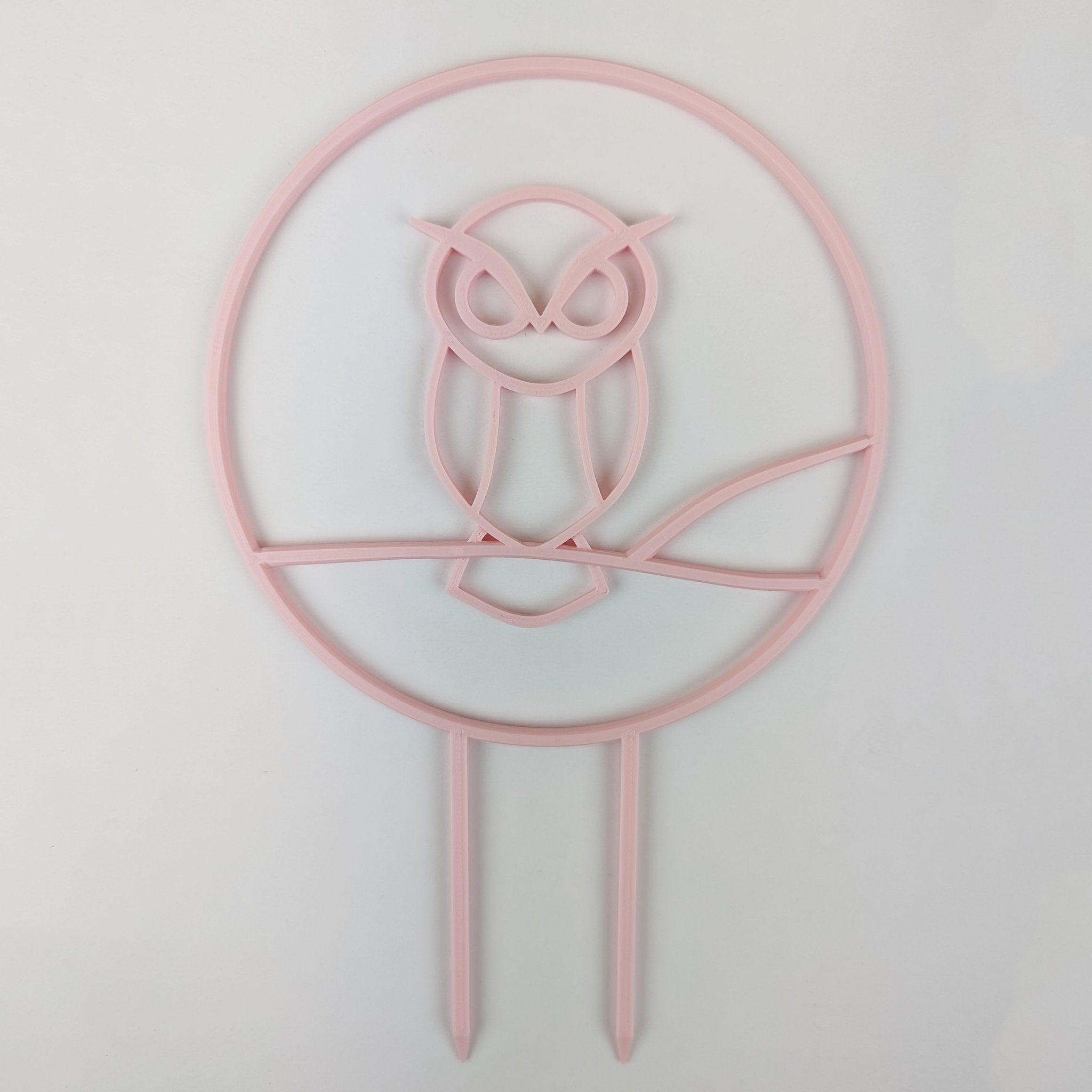 Owl trellis, a circle with an owl silhouette inside, in pastel pink
