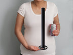 Extendable plant pole shown against a torso for height reference