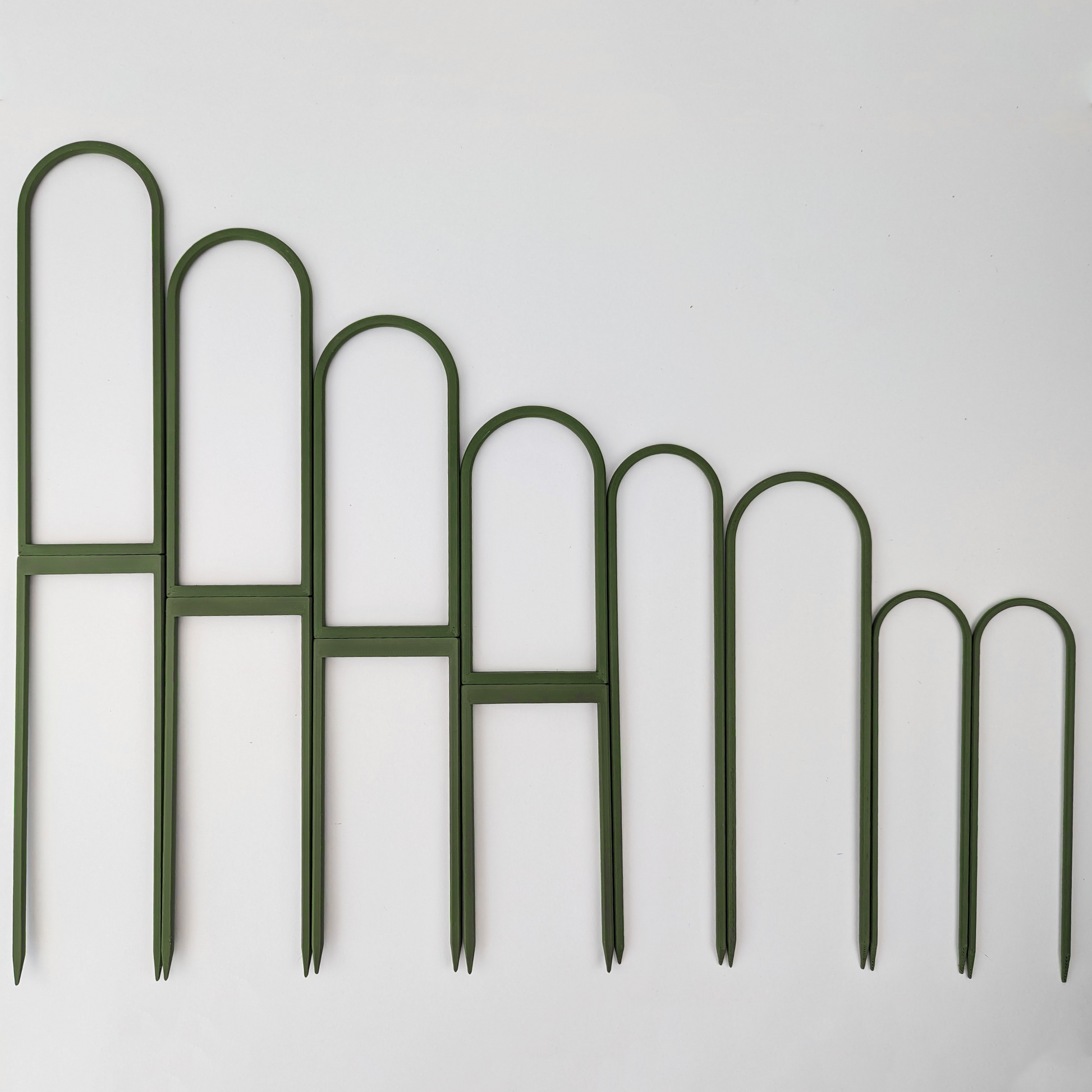 All sizes of U trellises, side by side ordered by size with largest on left. Green color.