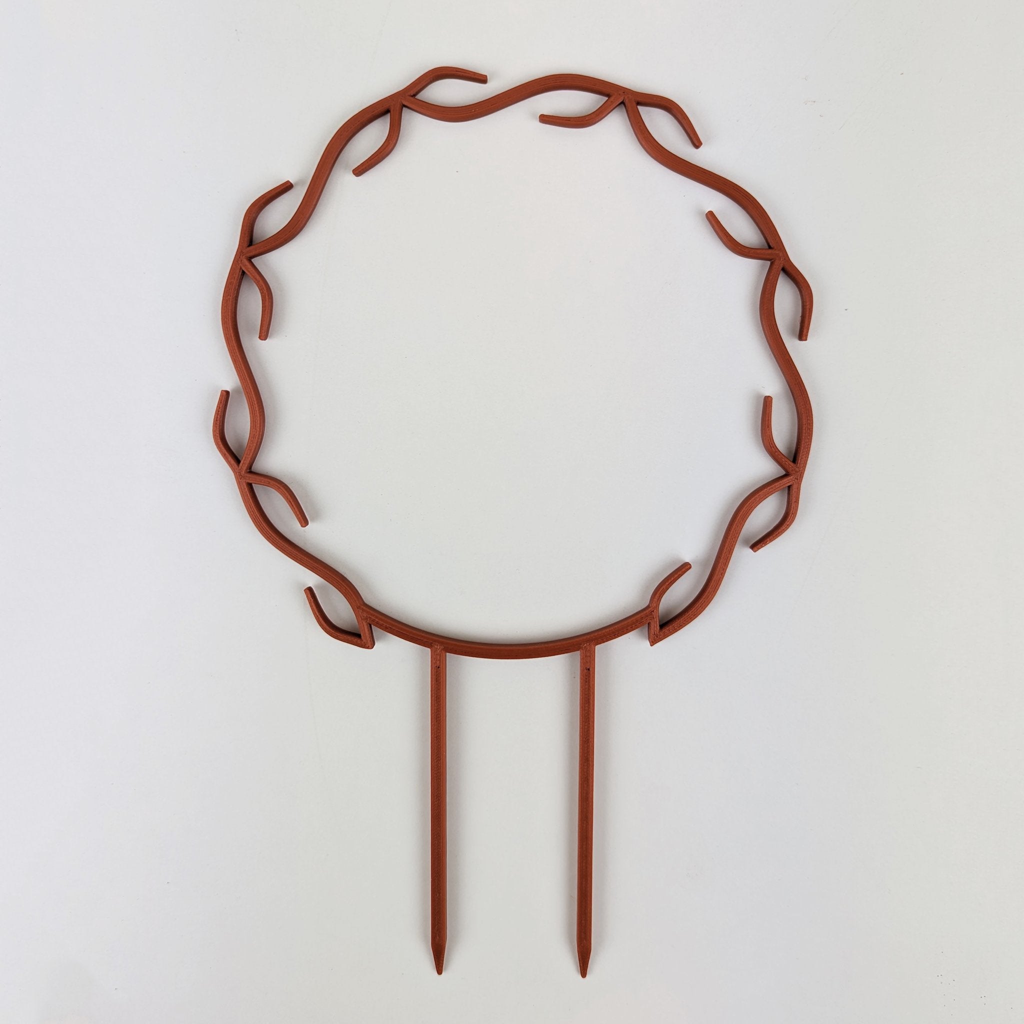Wreath trellis in copper, built-in hooks circling like a wreath