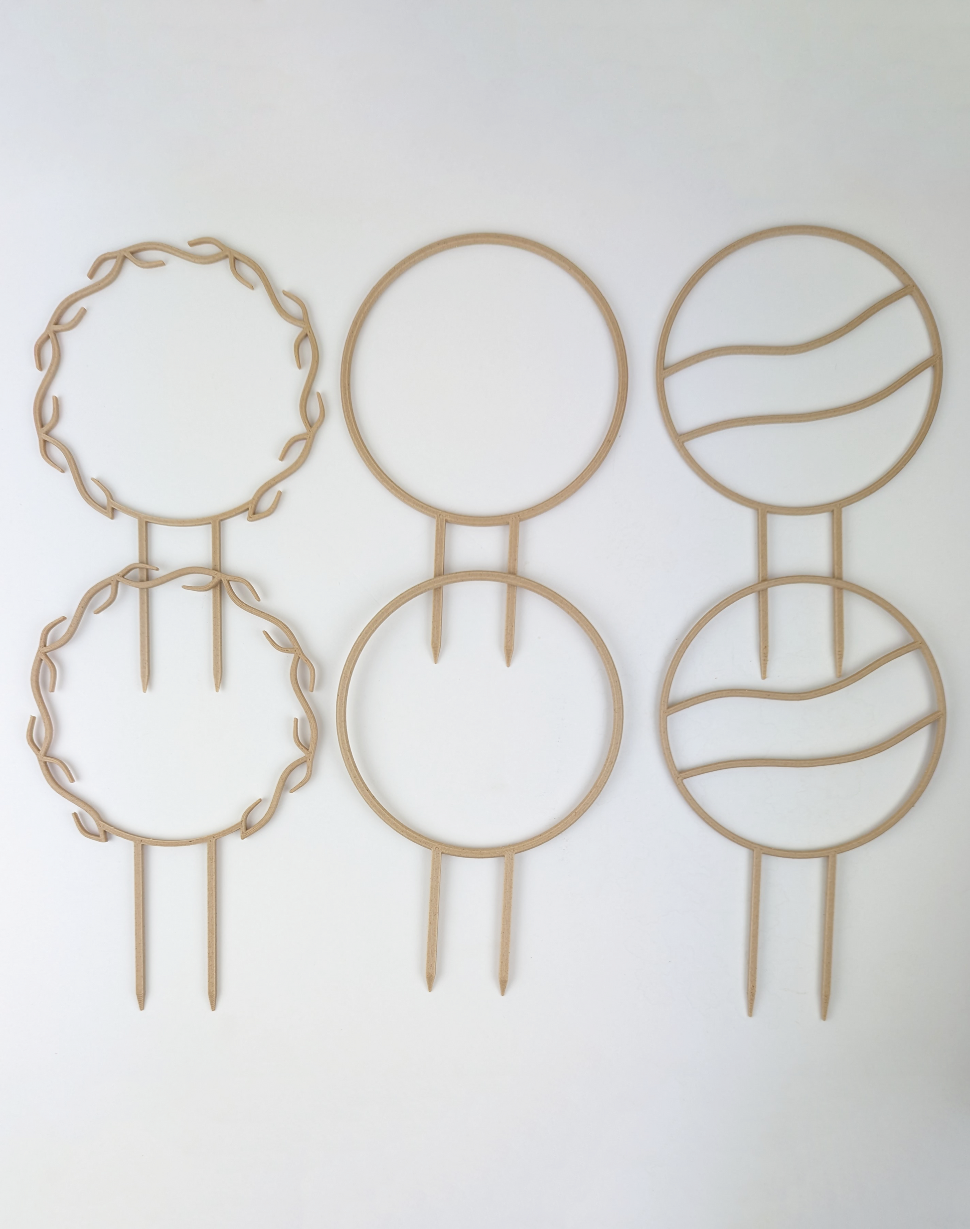 2 wreath, 2 circle and 2 wavy circle trellises in wood color.