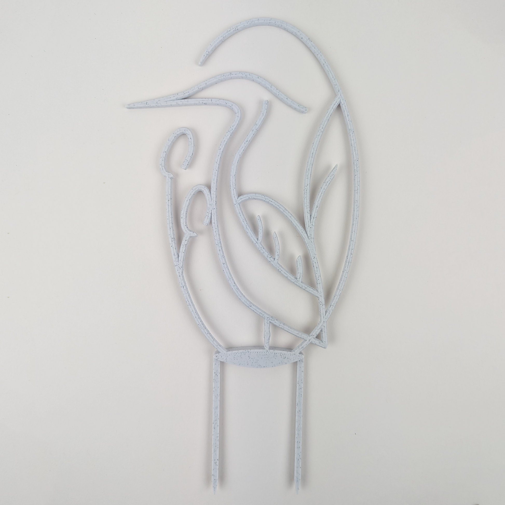 Houseplant trellis in the shape of a heron, in marble color against a plain white background.