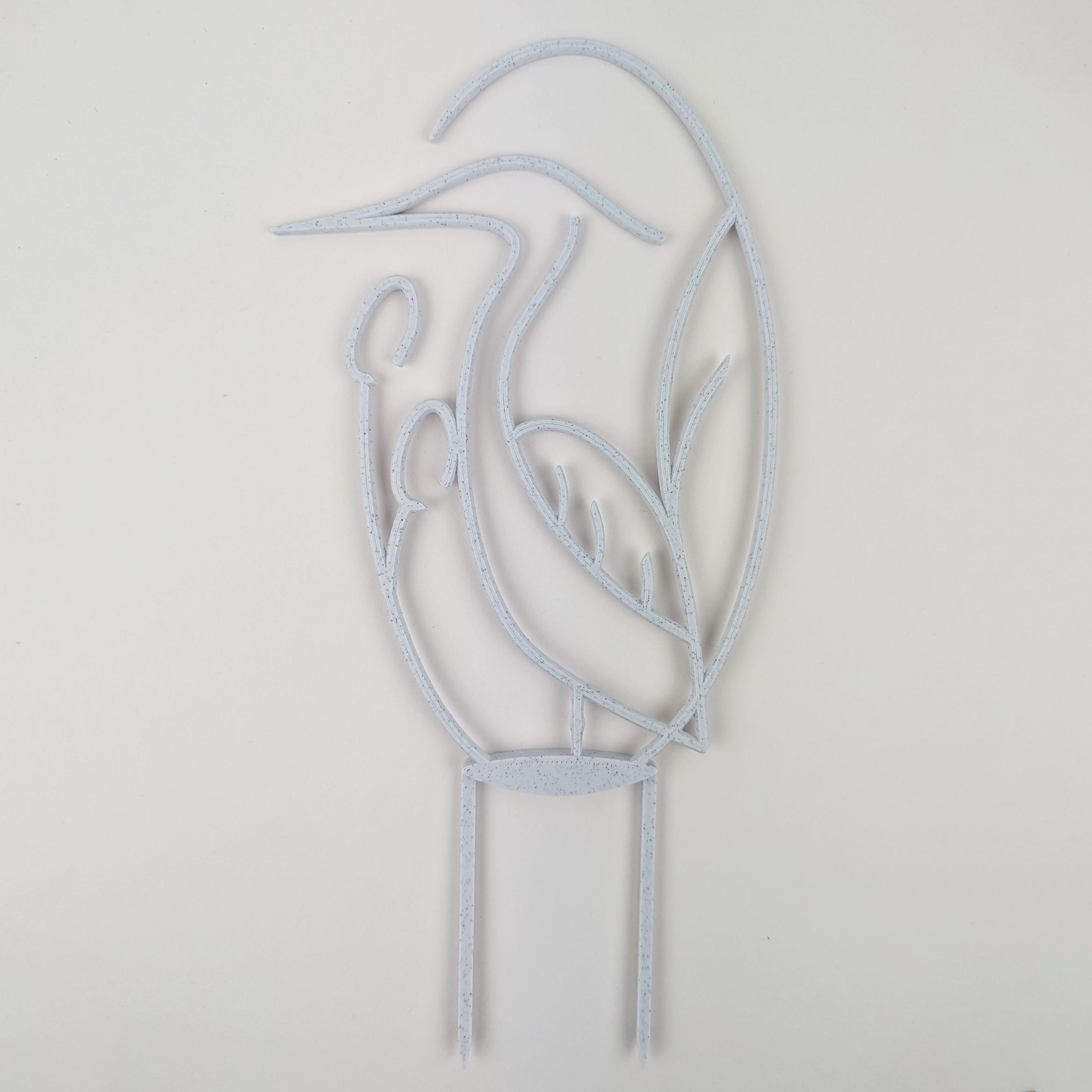 Houseplant trellis in the shape of a heron, in marble color against a plain white background.