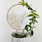 Hummingbird trellis in wood color with hoya vine wrapped around it