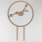 Sloth circle trellis in a wood finish, a sloth hanging from a branch inside the circle