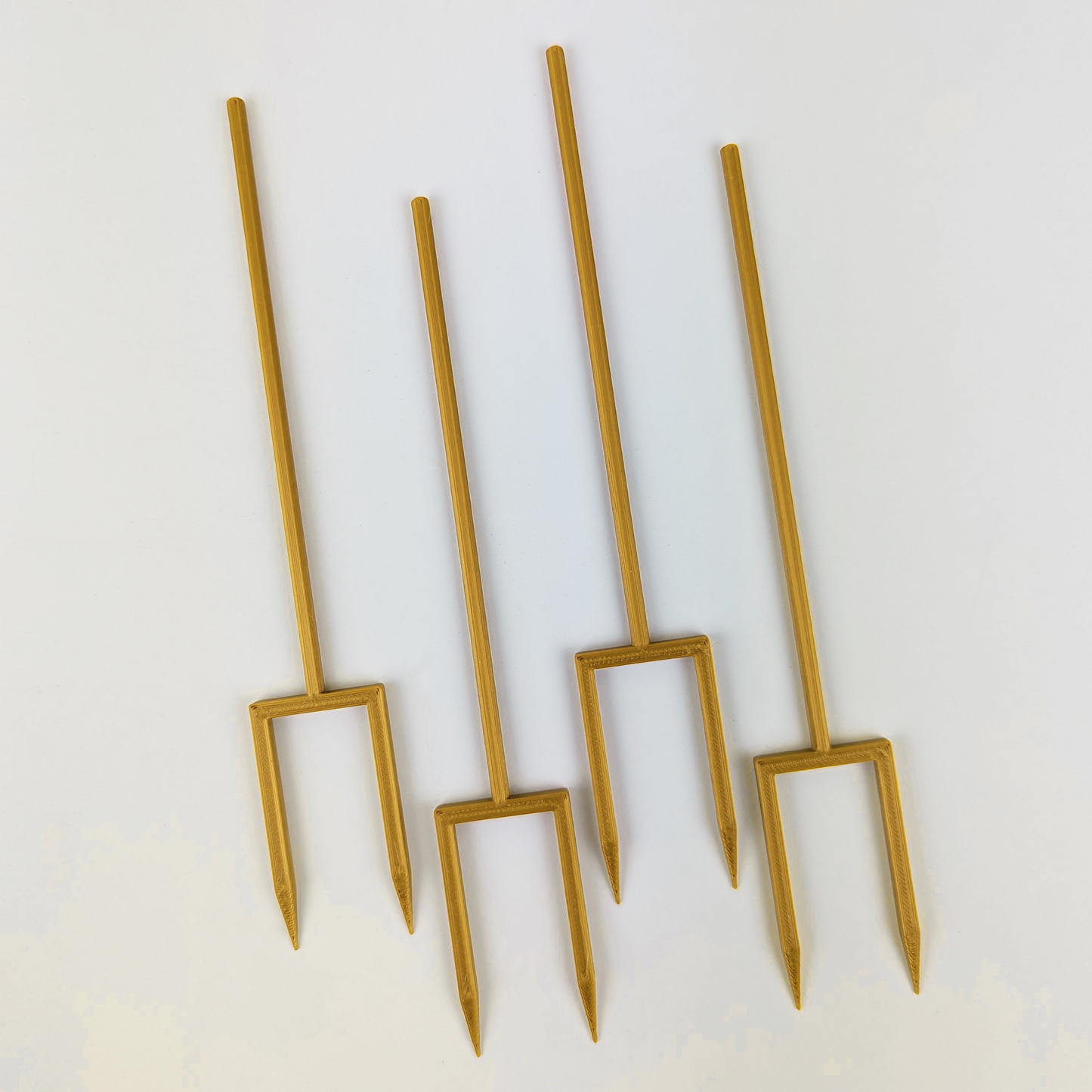 4 double legged stakes in the color gold