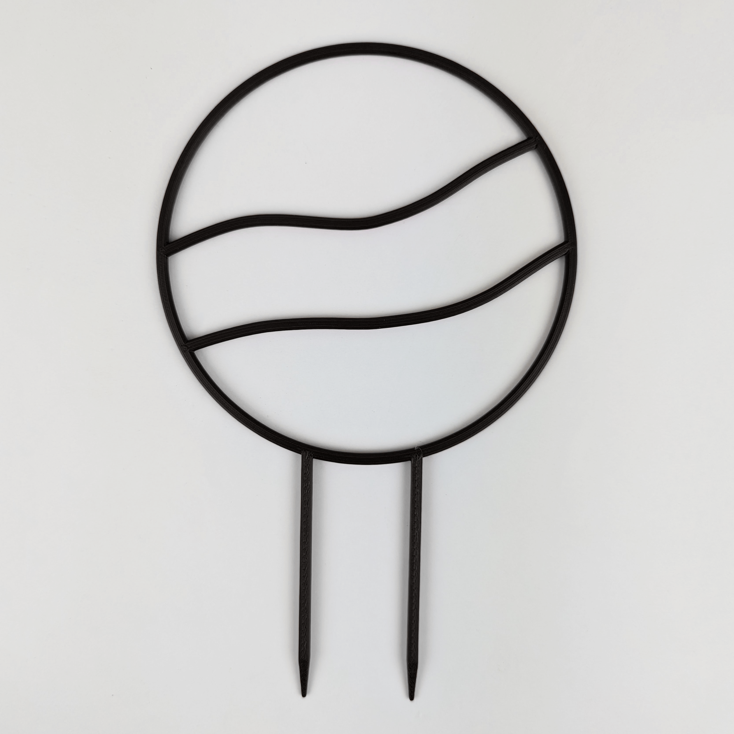 A circle trellis with two horizontal wavy lines running across the middle. It is against a white background. The colour of the trellis is black.