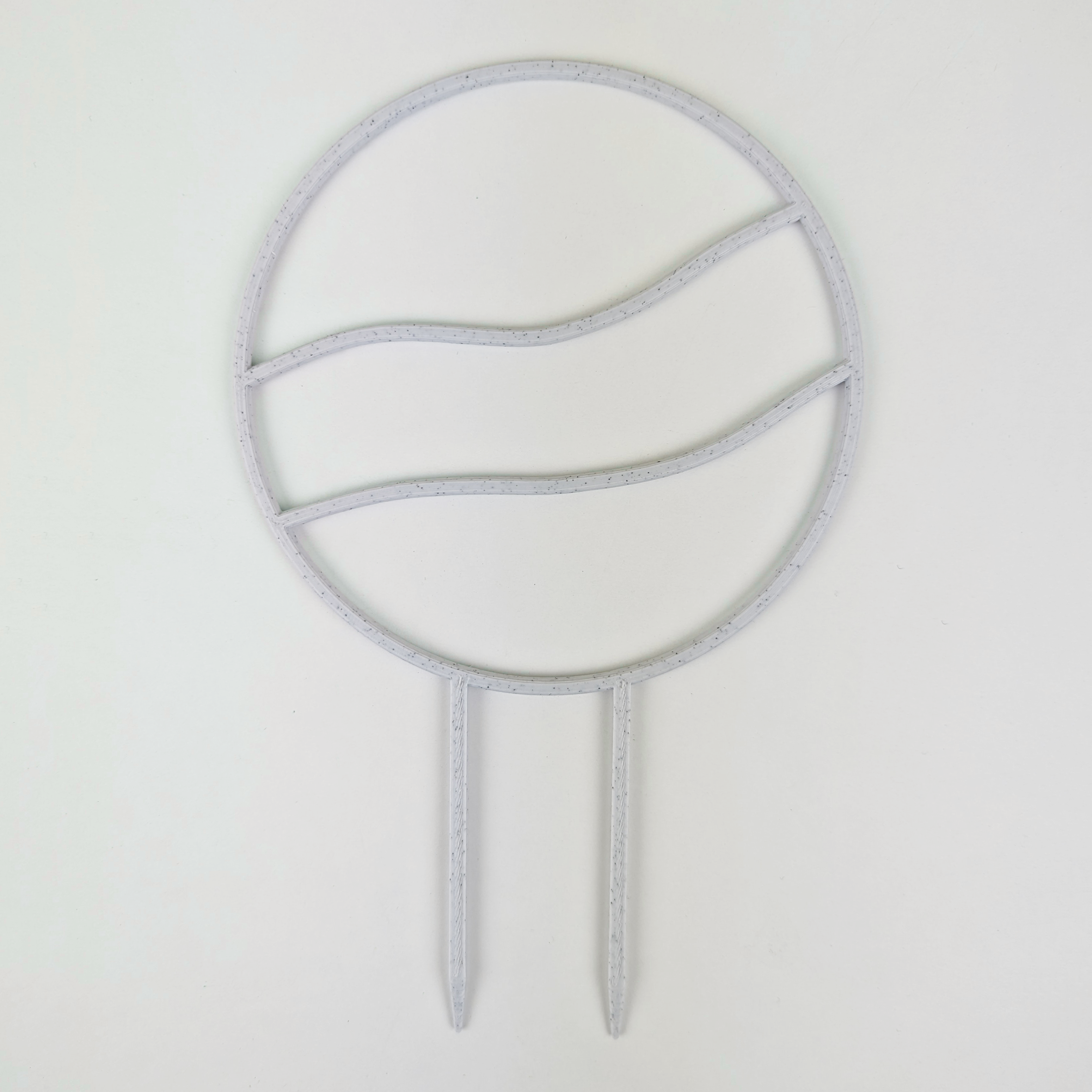 A circle trellis with two horizontal wavy lines running across the middle. It is against a white background. The colour of the trellis is marble.